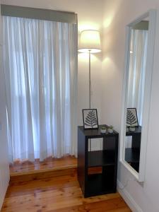 a room with a table with a lamp and a window at Domus Montebello in Rome