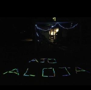 a lit up sign in front of a house with lights at Ajo Aloha Hostel in Cabo Polonio