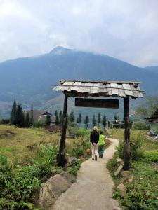 a man and a child walking down a path at Sapa's soul hillside in Sa Pa