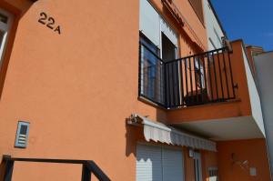 un edificio arancione con balcone e porta di Apartment Meli a Sesvete