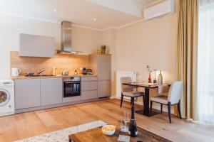 a kitchen with a table and a dining room at Hotel Villa Toskana in Leimen