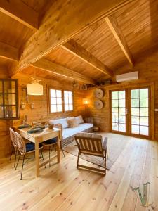 a room with a bed and a table and chairs at Vale do Laranjal in Setúbal