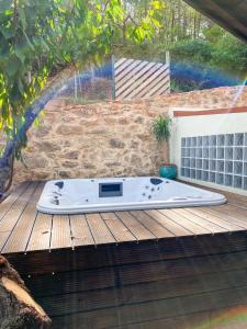 a hot tub sitting on a wooden deck at Vale do Laranjal in Setúbal