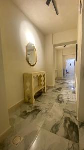 a hallway with a mirror and a marble floor at Amman Trail Hotel & Studios in Amman