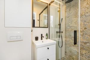 a bathroom with a sink and a shower at Grapa Ski - apartament Białka Tatrzańska in Białka Tatrzanska