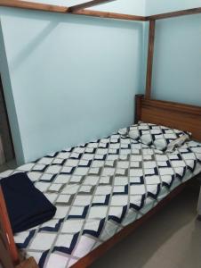 A bed or beds in a room at Srinilayam