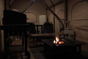 a room with a fire in a tent at Aank Ryokan Yosuriguri Hotel in Cheonan