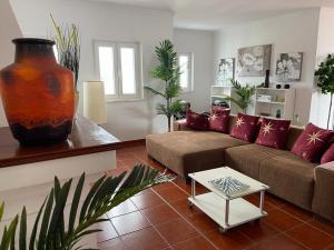 a living room with a couch and a table at Penthouse Alentejana in Vila Nova de Milfontes