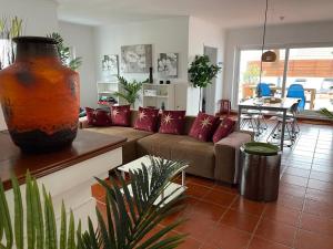 a living room with a couch and a table at Penthouse Alentejana in Vila Nova de Milfontes