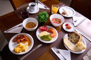 un tavolo con piatti per la colazione di Foz Plaza Hotel a Foz do Iguaçu