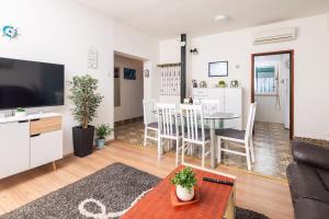 a living room with a couch and a table at Urban Edge - Beach Apartments in Omiš