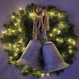 two bells hanging on a christmas wreath at Hotel Zur Luppbode in Treseburg