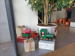 a group of christmas presents in front of a potted tree at Hotel BESTPRICE Alcalá in Madrid