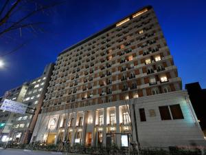 a large building with lights on in front of it at Hotel Monterey Kyoto in Kyoto