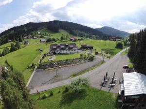 arial view of a house in a field with a road at Penzion Silverado in Horní Bečva