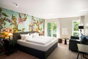 Giường trong phòng chung tại ANA Living Karlsruhe by Arthotel ANA