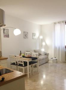 a living room with a table and a couch at Casa Pallamaio Historic Center Vicenza in Vicenza