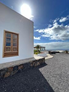 a window on the side of a white building at Finca Isolina Hotel Boutique - Adults Recommended in Mácher