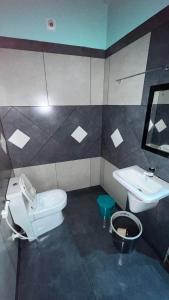 a bathroom with a toilet and a sink at Welldone Wayanad Holidays in Sultan Bathery