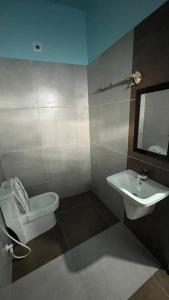 a bathroom with a toilet and a sink at Welldone Wayanad Holidays in Sultan Bathery