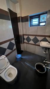 a bathroom with a toilet and a sink at Welldone Wayanad Holidays in Sultan Bathery