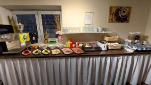 a counter with food items on top of it at Alcorso Pension in Banská Bystrica