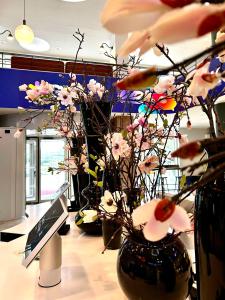 a room with two vases with flowers in it at Hotel Berlin, Berlin, a member of Radisson Individuals in Berlin