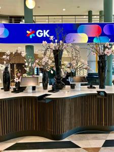 a counter with vases of flowers in a store at Hotel Berlin, Berlin, a member of Radisson Individuals in Berlin