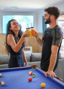 a man and a woman holding a glass of orange juice at Motel Sunshine Coast in Caloundra