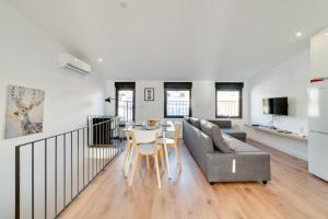 a living room with a couch and a table at Lapa Duplex Apartment in Lisbon