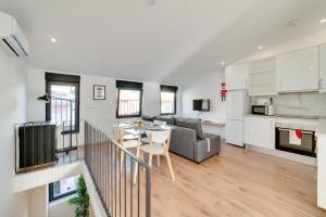 a living room with a couch and a table at Lapa Duplex Apartment in Lisbon