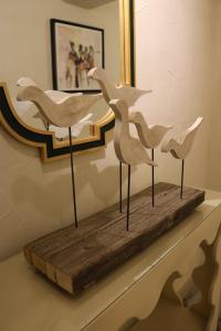 a group of white birds sitting on a wooden board at Amman Trail Hotel & Studios in Amman