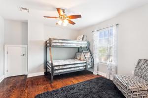 a room with a bunk bed and a ceiling fan at Amazing 3bedroom townhome, in Historic Dryade City in New Orleans