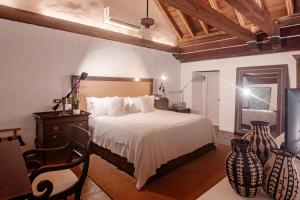 a bedroom with a bed and a table and a chair at Amarla Boutique Hotel Cartagena in Cartagena de Indias