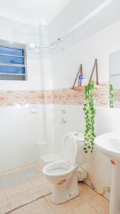 a bathroom with a toilet and a sink at Maya Homes in Naivasha