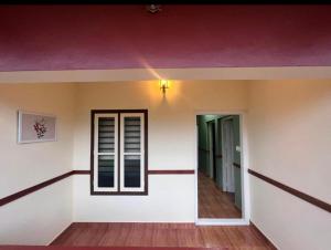 a room with a purple ceiling and a window at Easy Inn Wayanad in Kaniyāmbetta