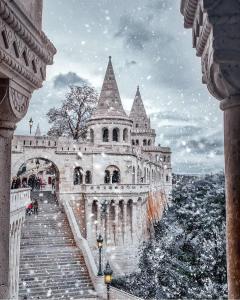 a castle with a staircase leading up to it at K40 Romantic Deluxe Studio In the City Center in Budapest