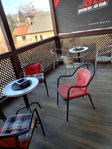 a group of chairs and tables on a patio at Apartment and rooms"Tabašnice"Tuzla centar in Tuzla