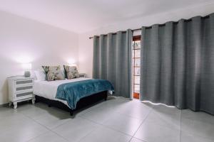 A bed or beds in a room at Cornerstone Guesthouse Alk Van Zyl