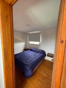 a bedroom with a blue bed in a room at Solar de la Viuda in Punta Del Diablo