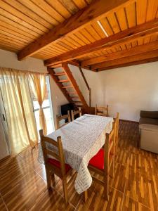 a dining room with a table and chairs and a couch at Solar de la Viuda in Punta Del Diablo