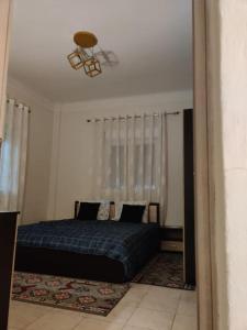 a bedroom with a blue bed and a ceiling at Amalias - city oasis in Thessaloniki