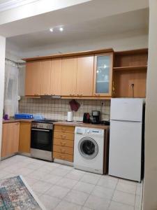 a kitchen with a white refrigerator and a washer at Amalias - city oasis in Thessaloniki