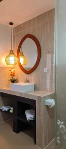 a bathroom with a sink and a mirror at ZiFa Mandalika in Kuta Lombok