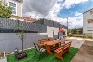 a patio with a wooden table and chairs at luxury apartment with garden jacuzzi in Trogir