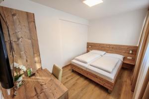 Tempat tidur dalam kamar di City Rooms Wels - contactless check-in