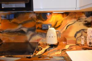 a coffee maker on a counter in a kitchen at Gemütliche Apartment Lucky und Lucky de Luxe in Bremerhaven