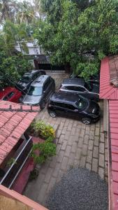 a group of cars parked in a parking lot at Dove cottage in Cherai Beach