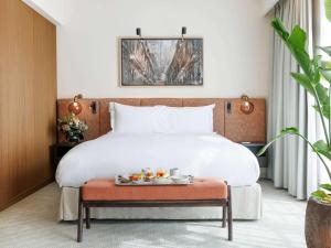 a hotel room with a bed with a tray of food on it at Sofitel Brussels Europe in Brussels