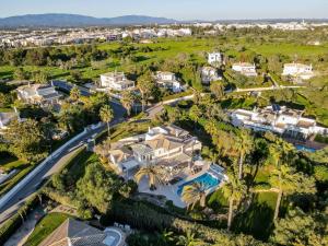 an aerial view of a mansion with a pool and palm trees at Alcore Luxury Golf Villa at Alto Golf Alvor in Alvor